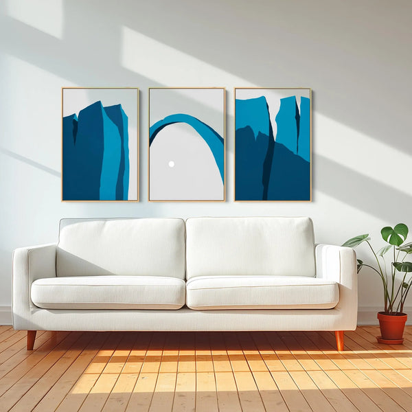 A set of three minimalist desert landscape canvas prints in blue.