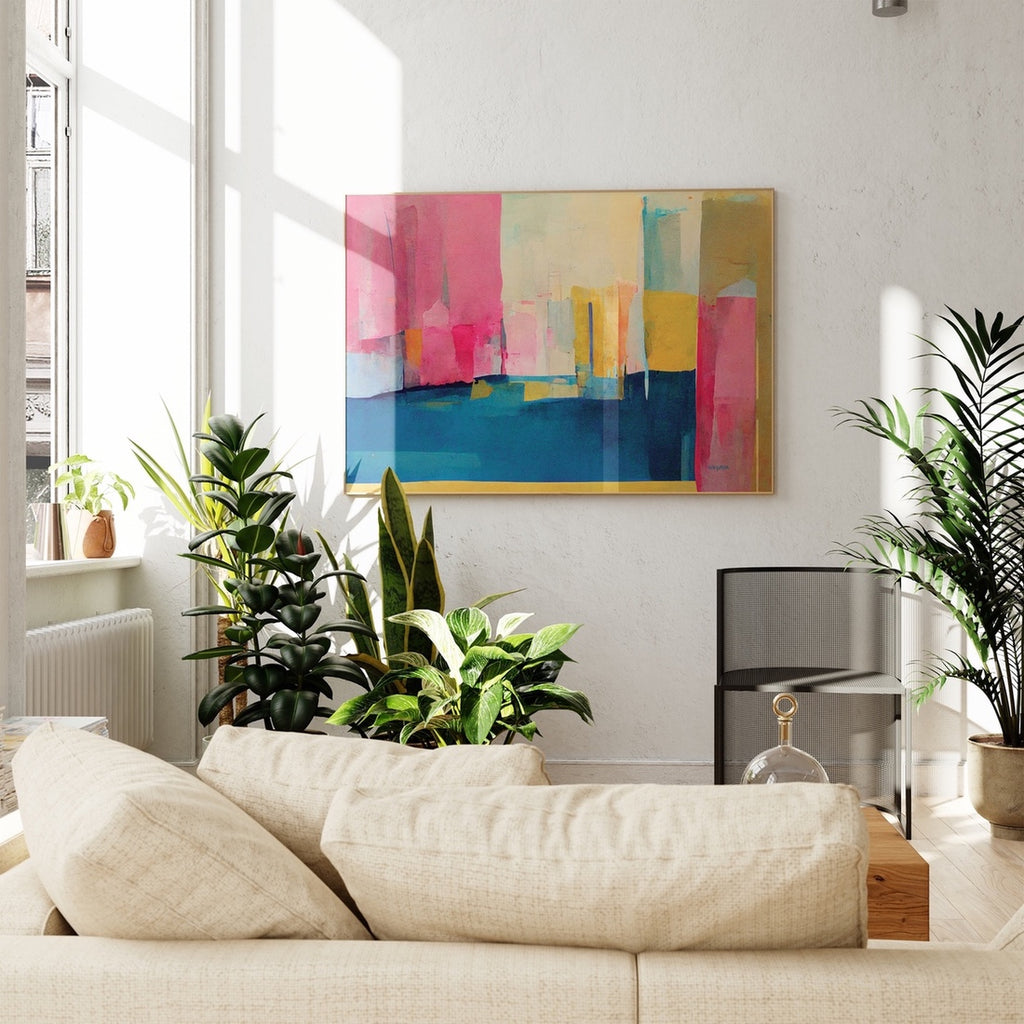 A set of four framed abstract wall art prints in pink, blue and yellow. 