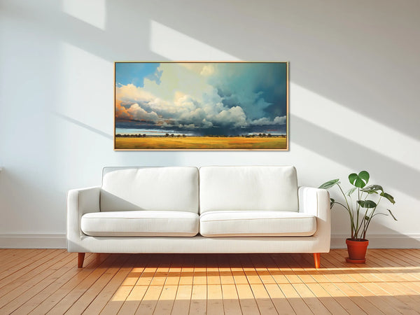 A framed landscape wall art featuring storm clouds rolling through.