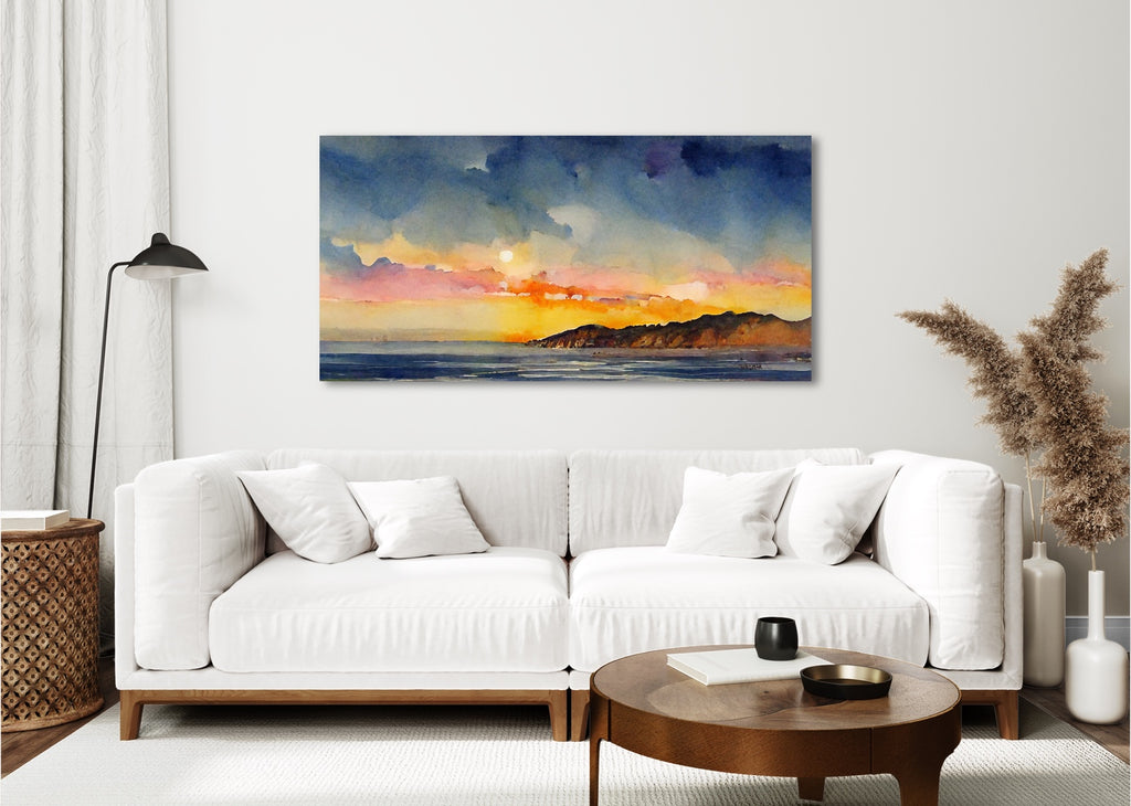 A framed horizontal abstract sunset painting in blue and orange.