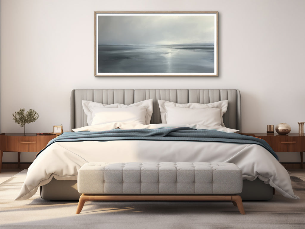A framed abstract coastal painting in neutral colors. 
