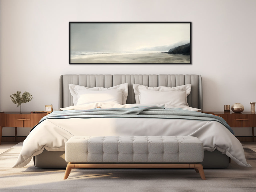 A framed horizontal coastal painting in neutral hues.