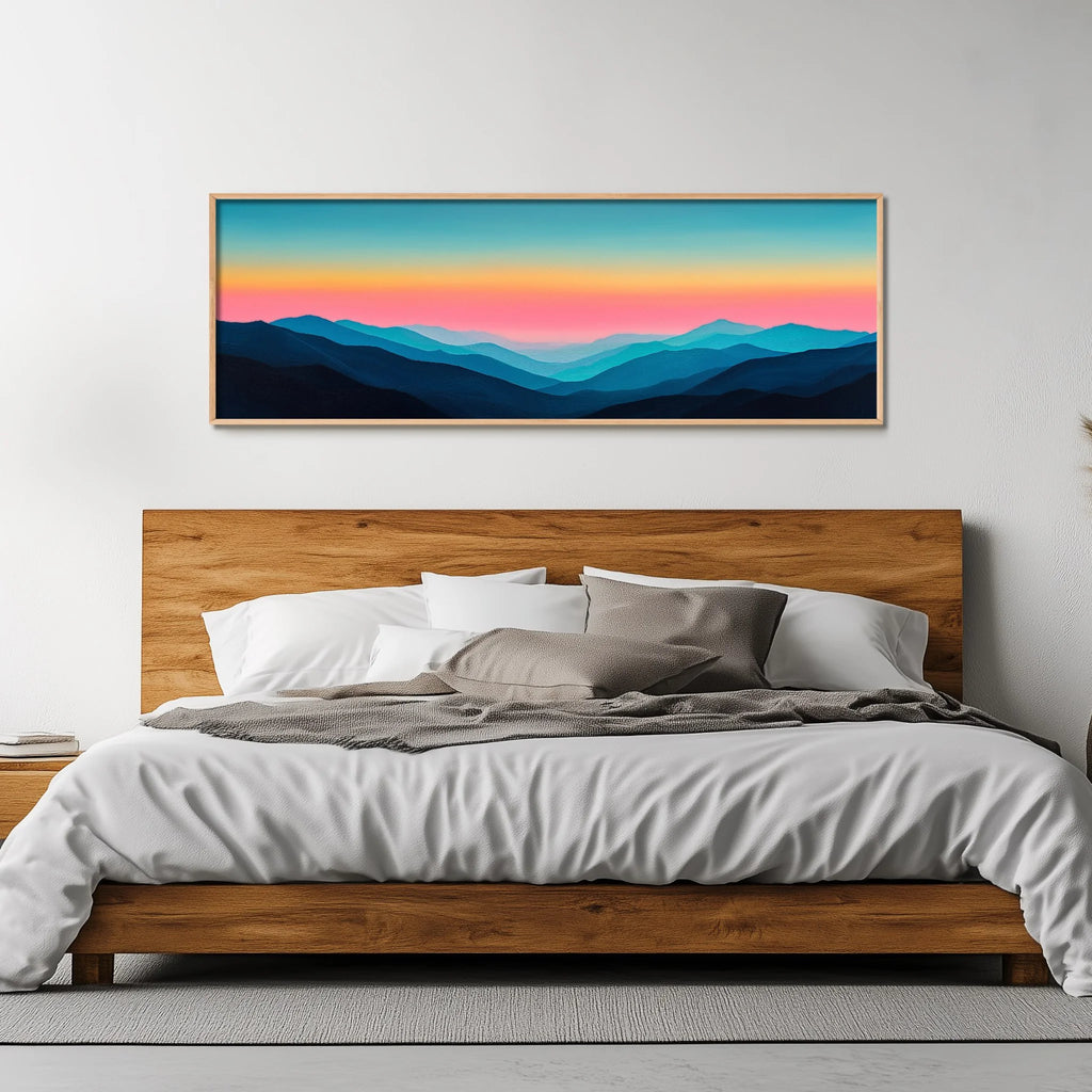 A panoramic print of minimalist blue mountains under a glowing sunset.