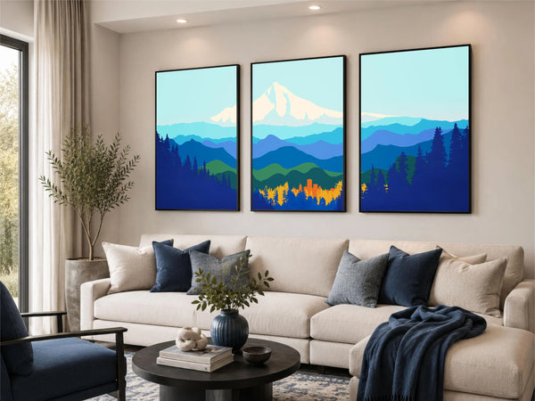 A three-panel framed wall art set depicting stylized blue mountain ranges, evergreen trees, and a snowy mountain peak.