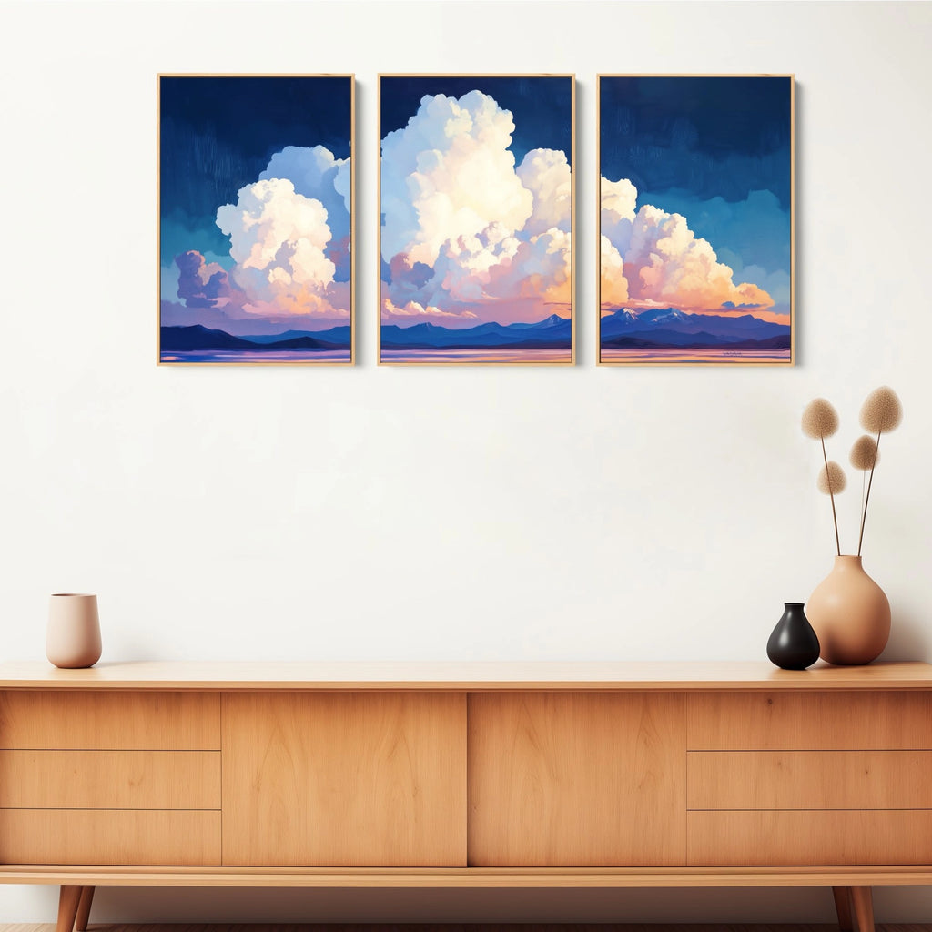 3 piece landscape print set featuring soft, white puffy clouds against a gentle sky.