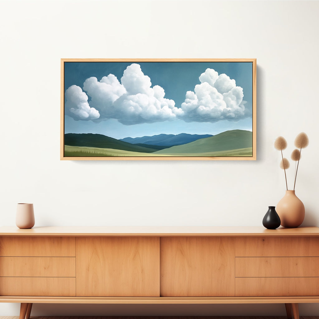 Large horizontal artwork featuring rolling green hills beneath a soft, white puffy cloud.