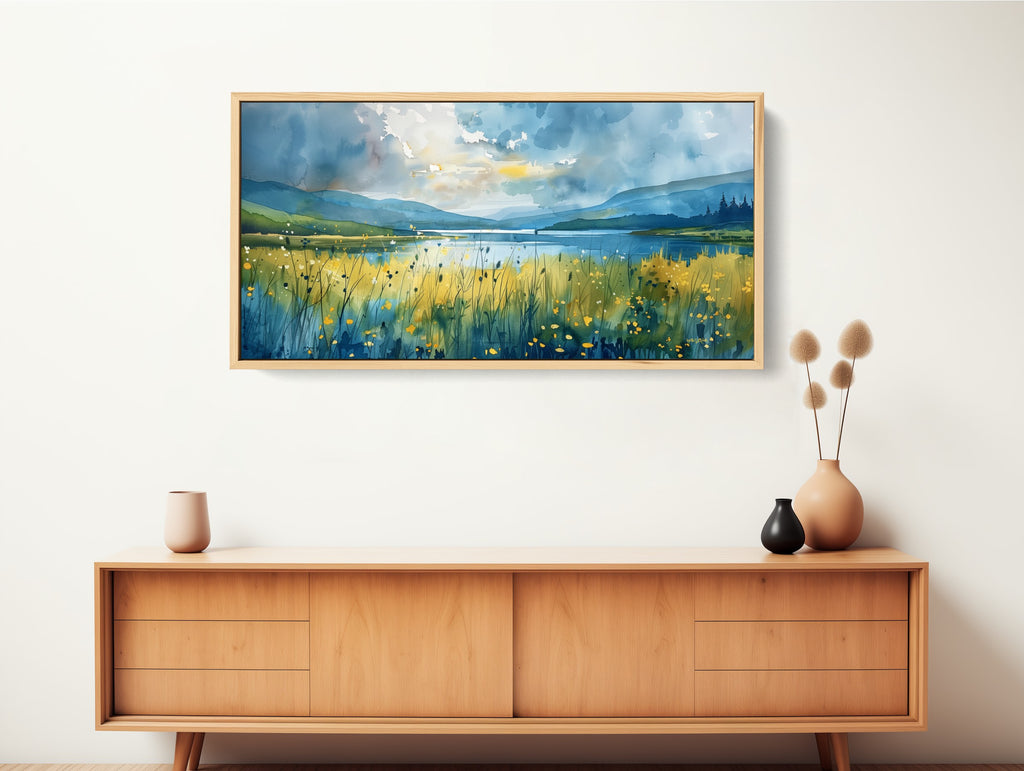 A modern watercolor artwork featuring a field of wild flowers by the water.