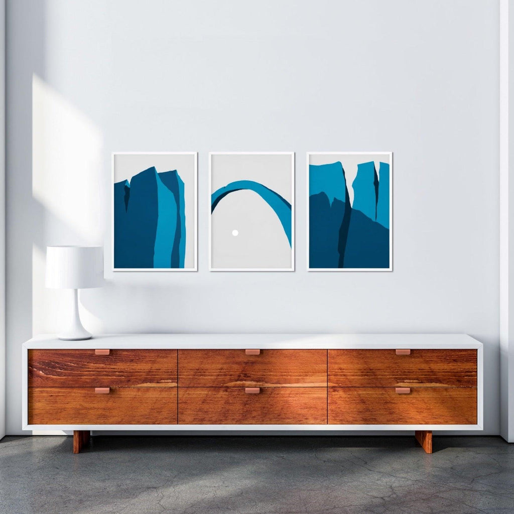 A set of three minimalist desert landscape canvas prints in blue.