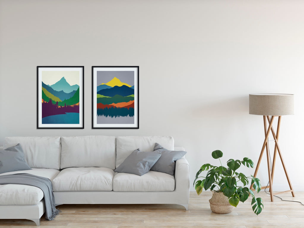 A set of 2 Pacific Northwest minimalist mountain prints in vibrant blues and greens with flashes of orange and yellow. 